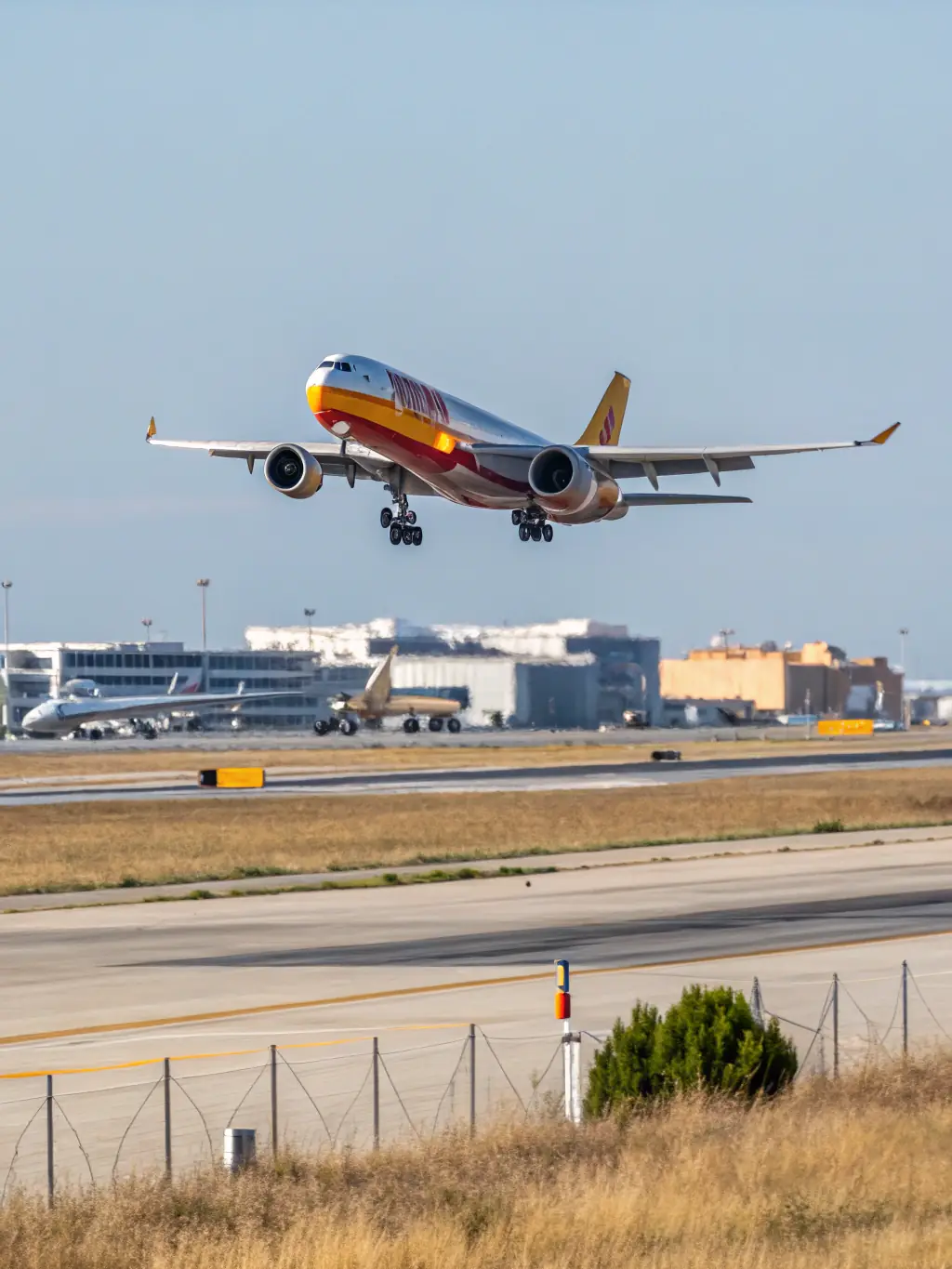 A modern cargo airplane taking off from an airport runway, representing fast and reliable air freight services for time-sensitive shipments.